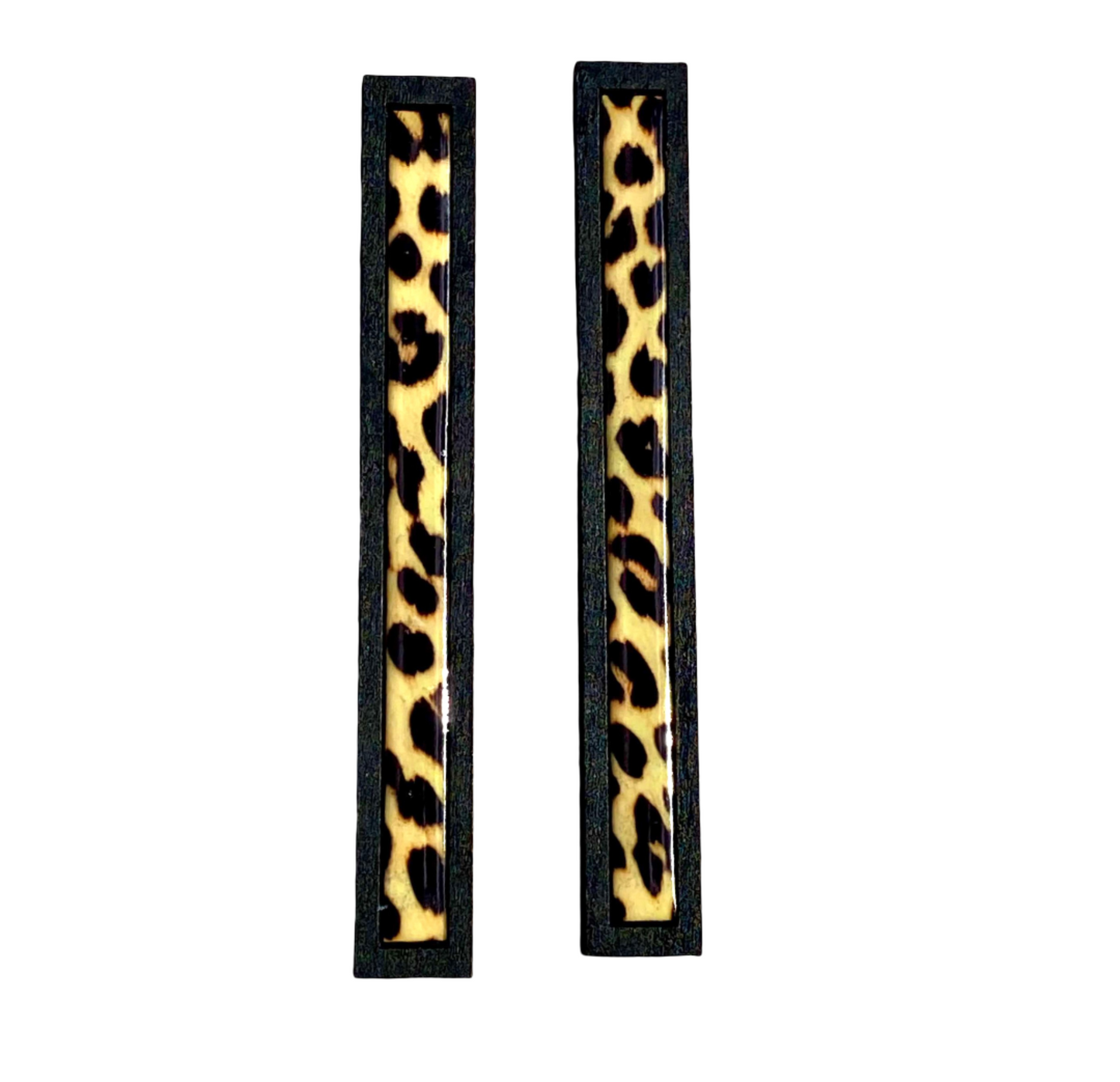 Pair of long rectangular earrings with leopard print design.