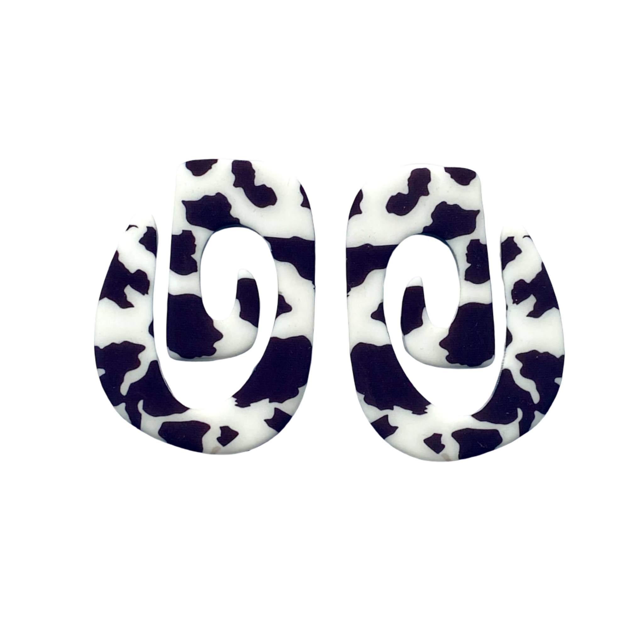 Pair of earrings with black and white cow print design.
