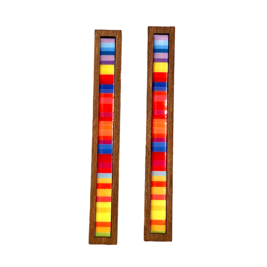 Pair of earrings with colorful striped design in wooden frames.